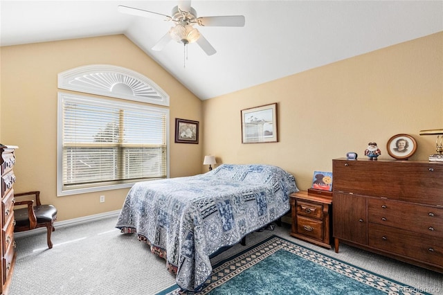 carpeted bedroom with baseboards, lofted ceiling, and a ceiling fan