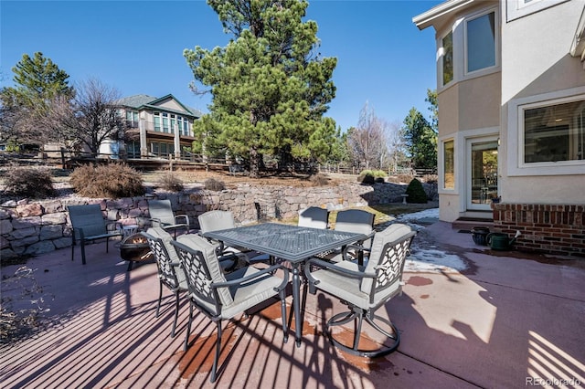 view of patio / terrace featuring an outdoor fire pit, outdoor dining space, and fence