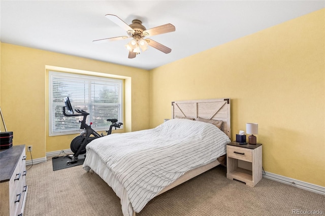 bedroom with light colored carpet, a ceiling fan, and baseboards