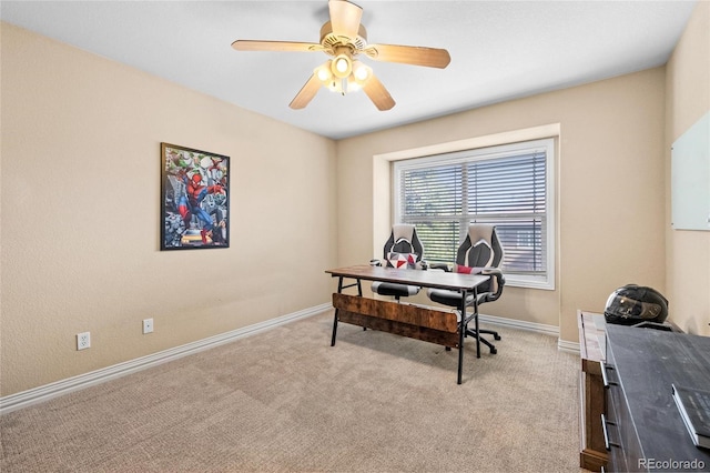 office with baseboards, light colored carpet, and a ceiling fan