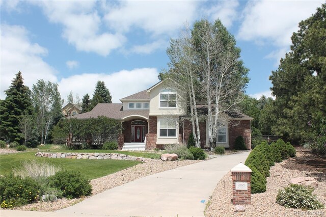 8389 Owl Roost Ct, Parker, CO 80134 - view of front facade featuring brick siding and a front yard