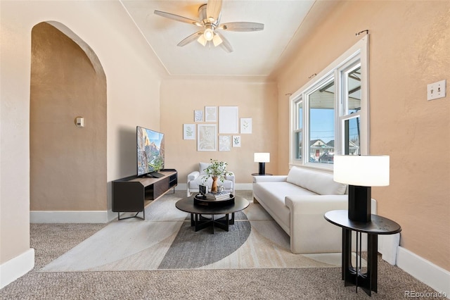 living room with ceiling fan and light colored carpet