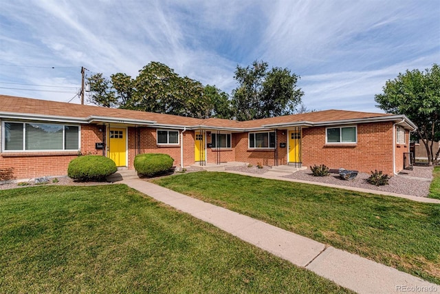 1331 Xanadu St, Aurora, CO 80011 - single story home with a front lawn and brick siding