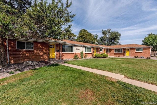1331 Xanadu St, Aurora, CO 80011 - single story home featuring brick siding and a front yard