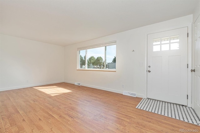 1331 Xanadu St, Aurora, CO 80011 - entrance foyer featuring light wood-style flooring and plenty of natural light