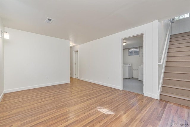1331 Xanadu St, Aurora, CO 80011 - empty room featuring separate washer and dryer, light wood finished floors, and stairs