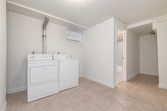 1331 Xanadu St, Aurora, CO 80011 - washroom featuring washer and dryer and light tile patterned flooring