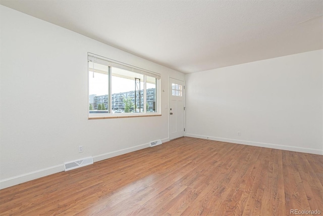 1331 Xanadu St, Aurora, CO 80011 - spare room featuring baseboards and light wood-type flooring
