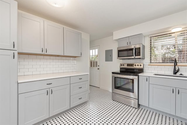 1331 Xanadu St, Aurora, CO 80011 - kitchen with stainless steel appliances, gray cabinets, light countertops, and electric panel