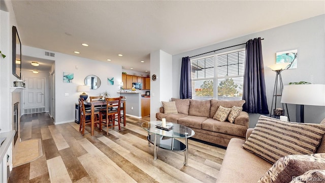 living room with light hardwood / wood-style flooring