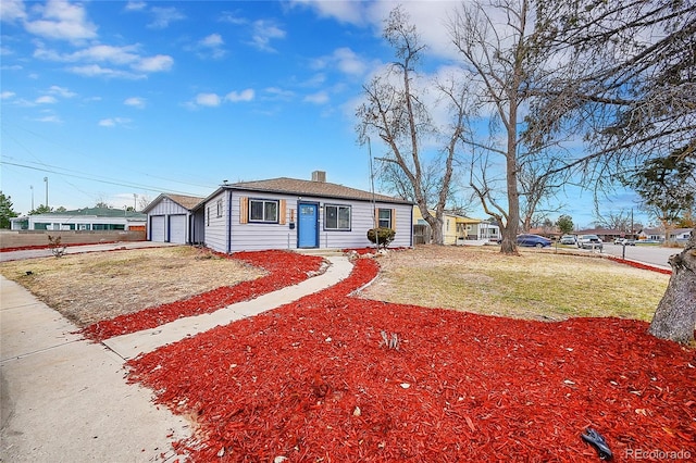 single story home featuring a front lawn and a garage