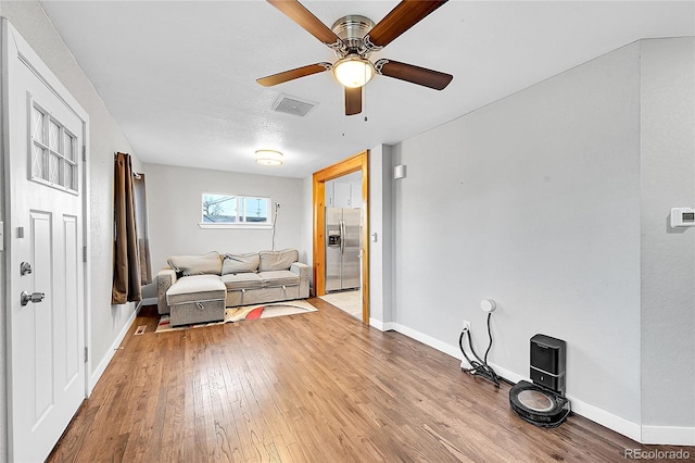 unfurnished living room featuring ceiling fan and light wood-type flooring