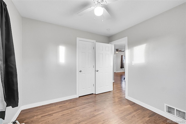 unfurnished bedroom with ceiling fan and light hardwood / wood-style flooring