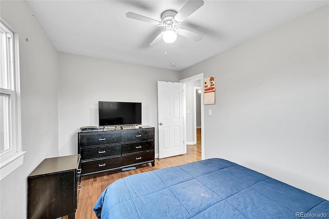 bedroom with ceiling fan and light wood-type flooring