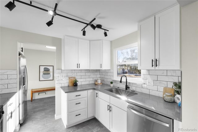 kitchen with stainless steel appliances, sink, and white cabinets