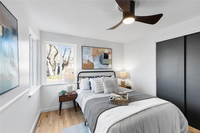 bedroom with a closet, ceiling fan, and light hardwood / wood-style flooring