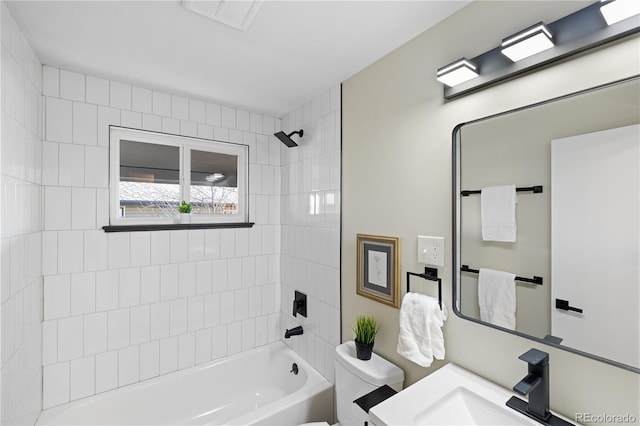 full bathroom featuring vanity, toilet, and tiled shower / bath combo