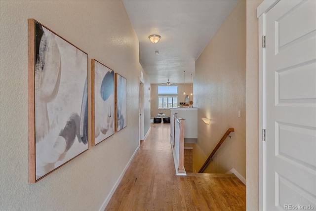 hallway with light hardwood / wood-style floors