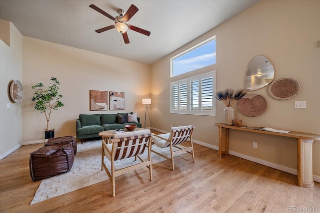 living room featuring ceiling fan and light wood-type flooring