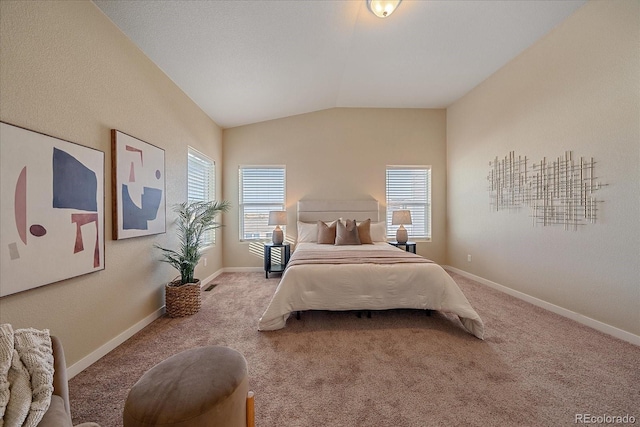 bedroom featuring vaulted ceiling and light colored carpet