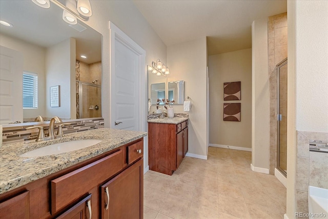 bathroom with tile patterned floors, vanity, and a shower with door