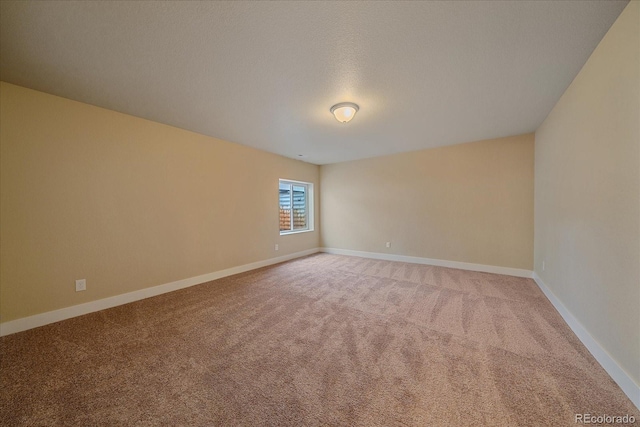 carpeted spare room with a textured ceiling