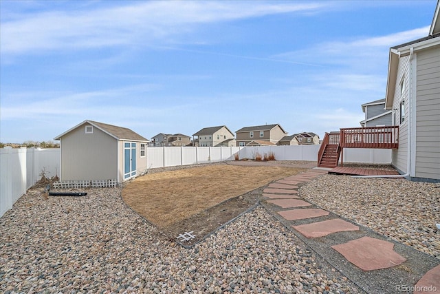 view of yard featuring a wooden deck and a storage unit