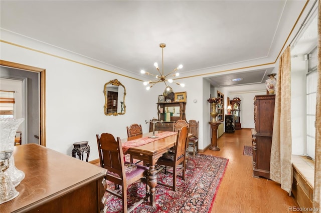 1475 S Monaco St Parkway, Denver, CO 80224 - dining space featuring a chandelier, light wood-type flooring, and ornamental molding