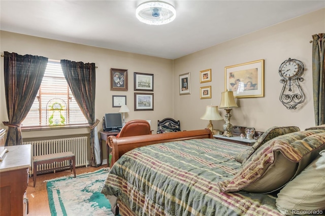 1475 S Monaco St Parkway, Denver, CO 80224 - bedroom with radiator heating unit and wood finished floors