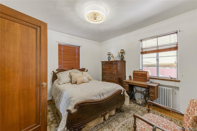 1475 S Monaco St Parkway, Denver, CO 80224 - bedroom featuring radiator heating unit and wood finished floors