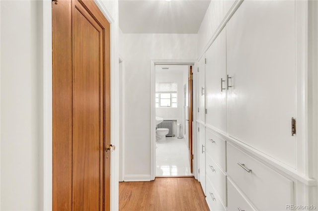 1475 S Monaco St Parkway, Denver, CO 80224 - hall featuring light wood-style floors and radiator heating unit