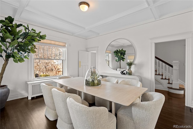 dining space featuring dark wood-style floors, radiator, coffered ceiling, and stairs