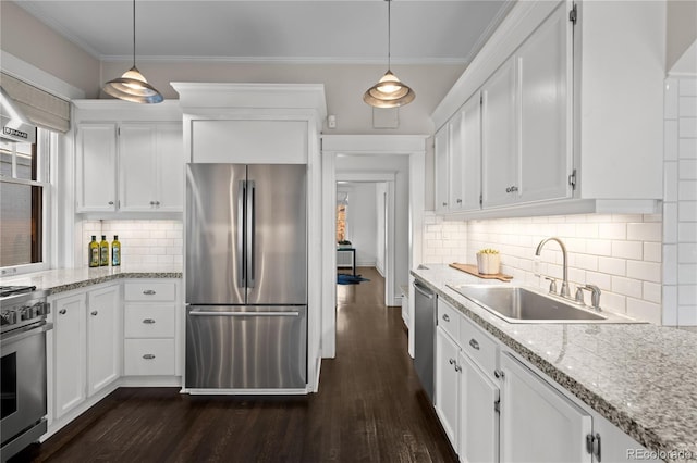kitchen with dark wood-style flooring, a sink, white cabinetry, appliances with stainless steel finishes, and crown molding