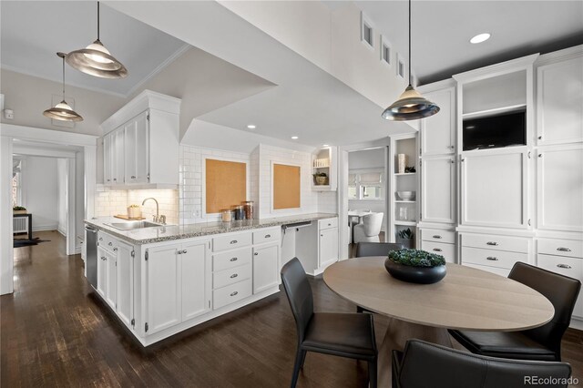 kitchen with white cabinetry, a sink, stainless steel dishwasher, and open shelves