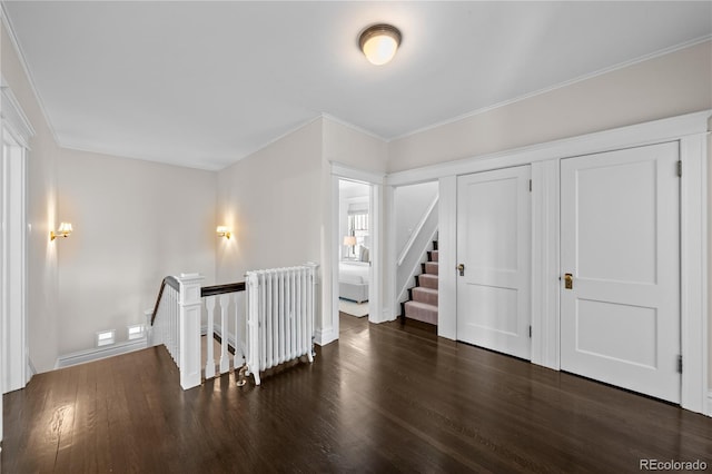 bonus room featuring radiator heating unit, wood finished floors, and baseboards