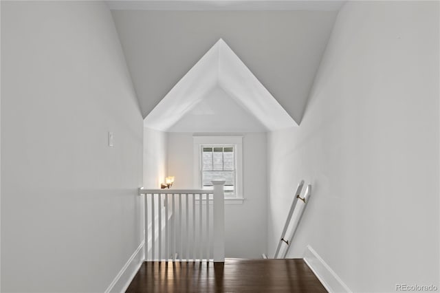stairway with baseboards and wood finished floors