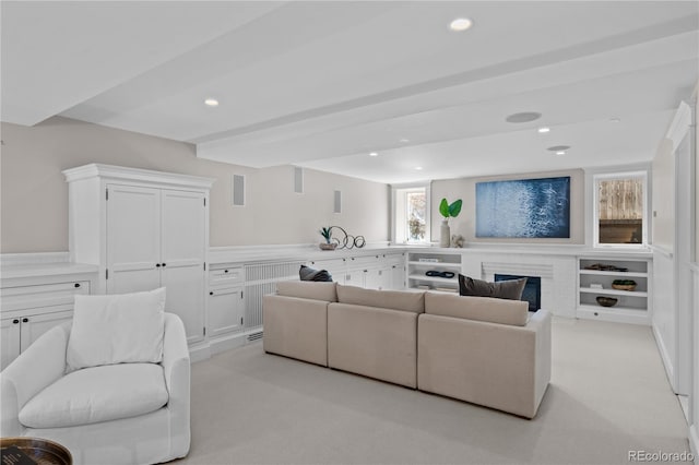 living room with recessed lighting and light carpet