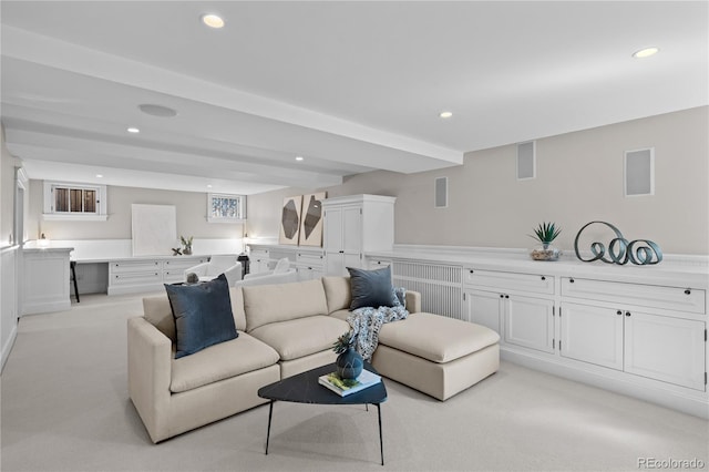 living area with recessed lighting and light carpet