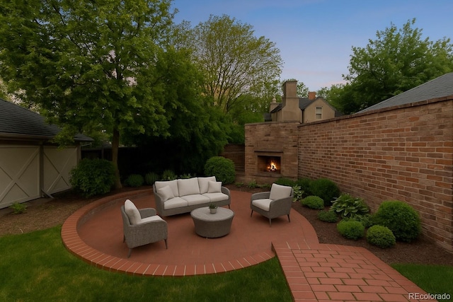 637 N Franklin St, Denver, CO 80218 - patio terrace at dusk with a patio and an outdoor living space with a fireplace