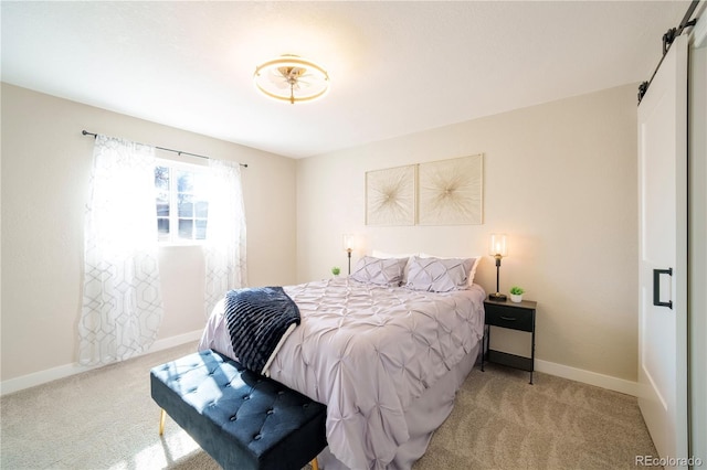 carpeted bedroom featuring a barn door