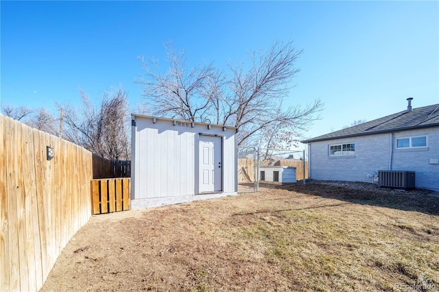 view of yard with cooling unit and an outbuilding