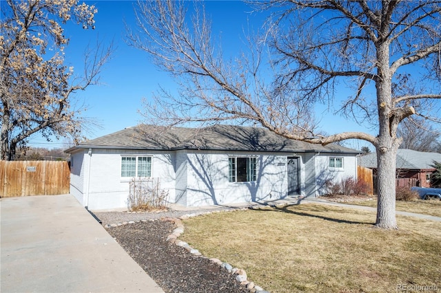 ranch-style house with a front yard, brick siding, fence, and roof with shingles