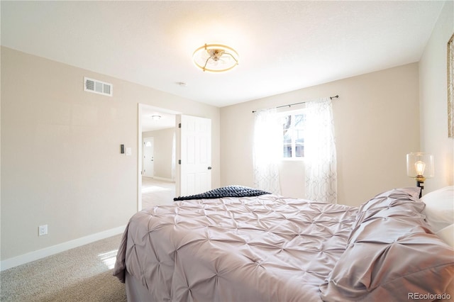 carpeted bedroom featuring visible vents and baseboards