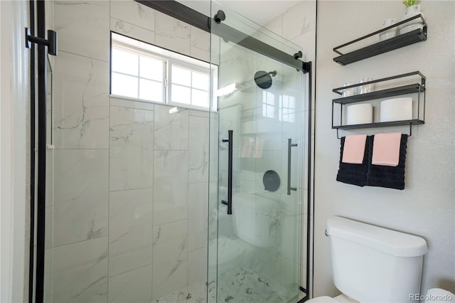 full bath featuring a marble finish shower and toilet