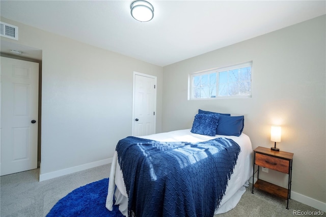 carpeted bedroom featuring visible vents and baseboards