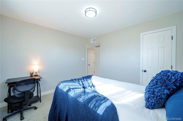 carpeted bedroom with visible vents and baseboards