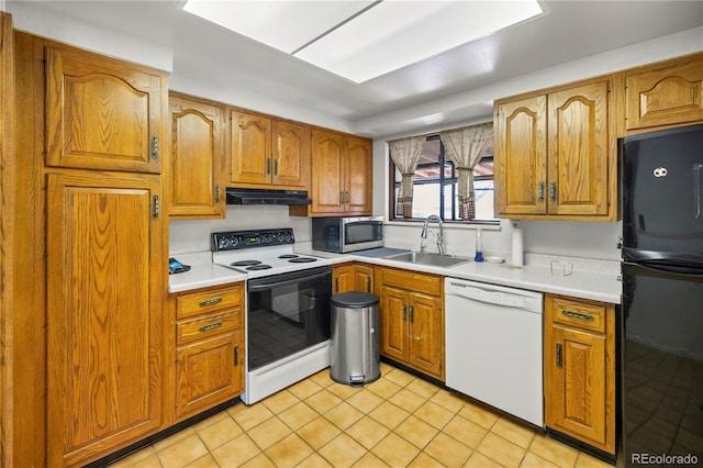 kitchen with white dishwasher, freestanding refrigerator, a sink, range with electric cooktop, and under cabinet range hood