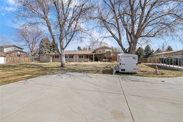 view of front of property featuring an outdoor structure, a front lawn, and fence