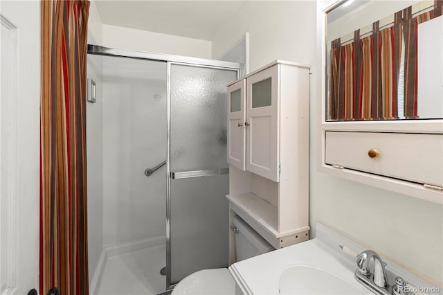 full bathroom with a shower stall, toilet, and vanity