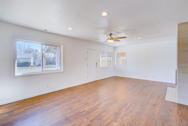 spare room featuring a ceiling fan, visible vents, wood finished floors, baseboards, and recessed lighting